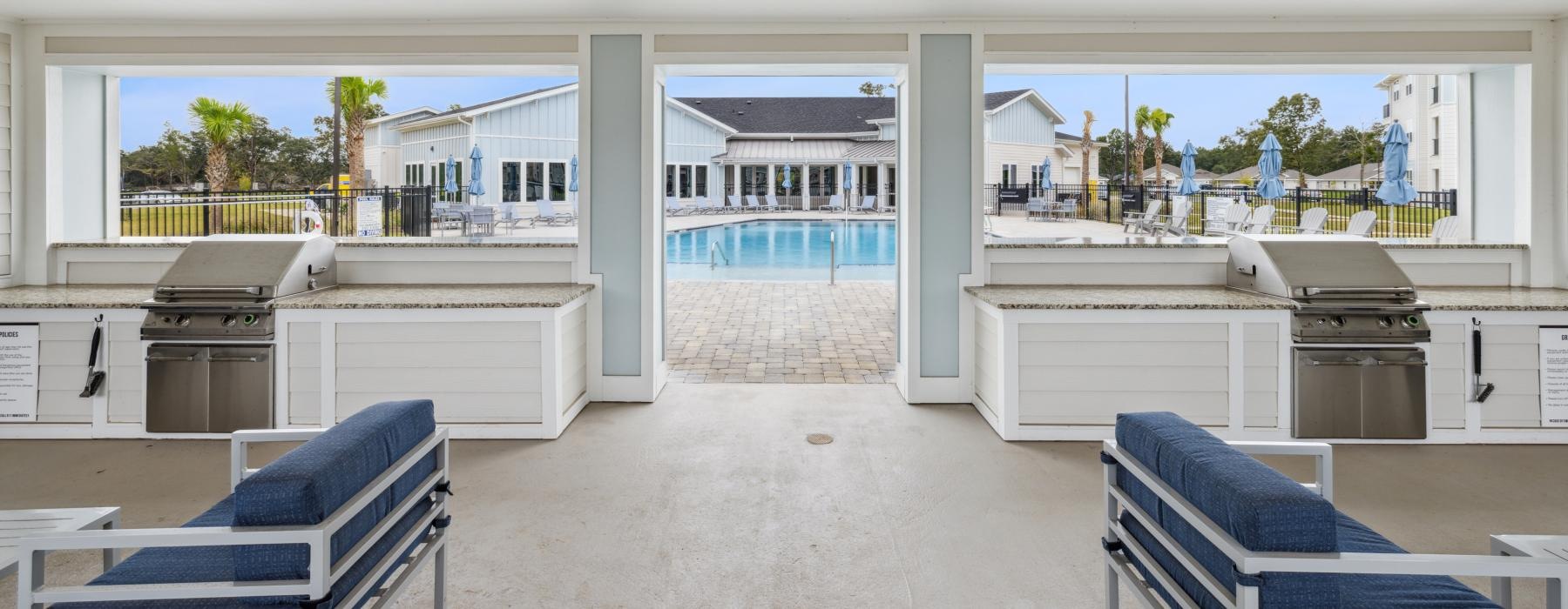 a large grilling area with a pool